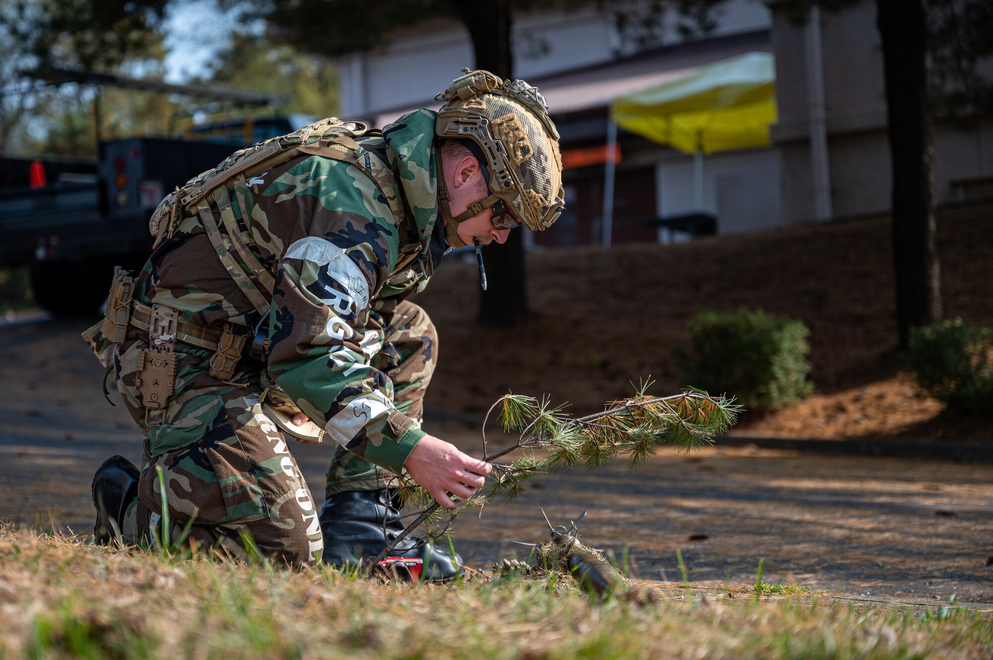 U.S. Air Force Staff Sgt. Carson Hudson, 51st Civil Engineer Squadron Explosive Ordnance Disposal team leader, removes a branch from a simulated unexploded ordnance during Vigilant Defense 24 at Osan Air Base, Republic of Korea, Oct. 31, 2023. VD24 is a routine training event that tests the military capabilities across the peninsula, allowing combined and joint training at both the operational and tactical levels. As the most forward deployed permanently based wing in the Air Force, the 51st Fighter Wing is charged with providing mission-ready Airmen to execute combat operations and receive follow-on forces. (U.S. Air Force photo by Staff Sgt. Thomas Sjoberg)