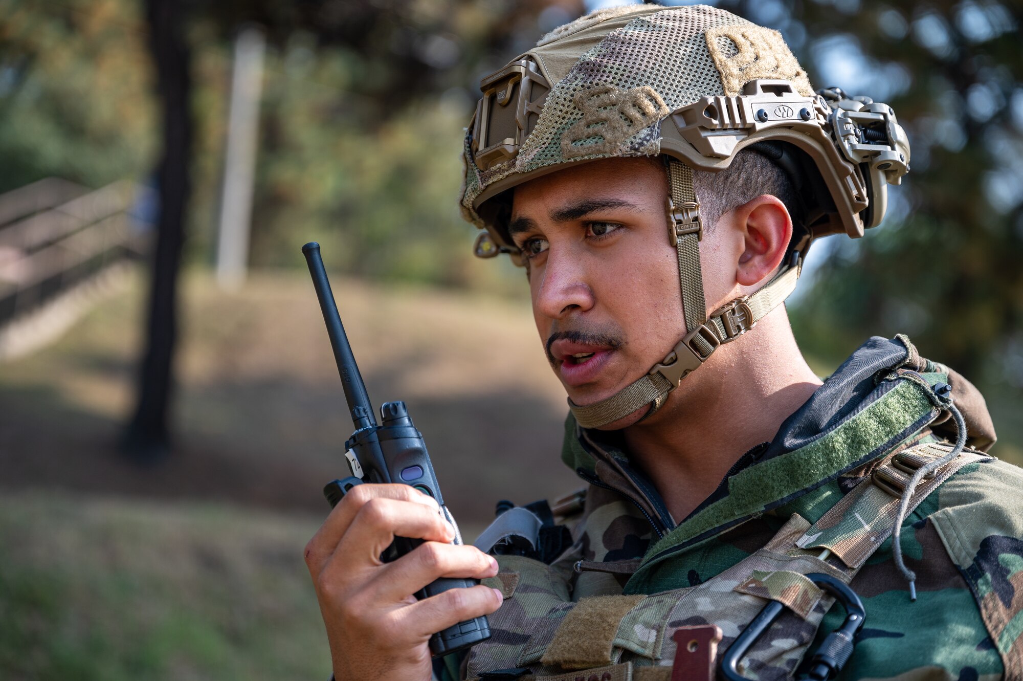 U.S. Air Force Senior Airman Noah Yates, 51st Civil Engineer Squadron Explosive Ordnance Disposal technician, communicates with his team leader while responding to a simulated unexploded ordnance call during Vigilant Defense 24 at Osan Air Base, Republic of Korea, Oct. 31, 2023. VD24 is a routine training event that tests the military capabilities across the peninsula, allowing combined and joint training at both the operational and tactical levels. The Airmen of the 51st Fighter Wing continuously train to maintain the high level of full-spectrum readiness required to execute the mission proficiently and effectively. (U.S. Air Force photo by Staff Sgt. Thomas Sjoberg)