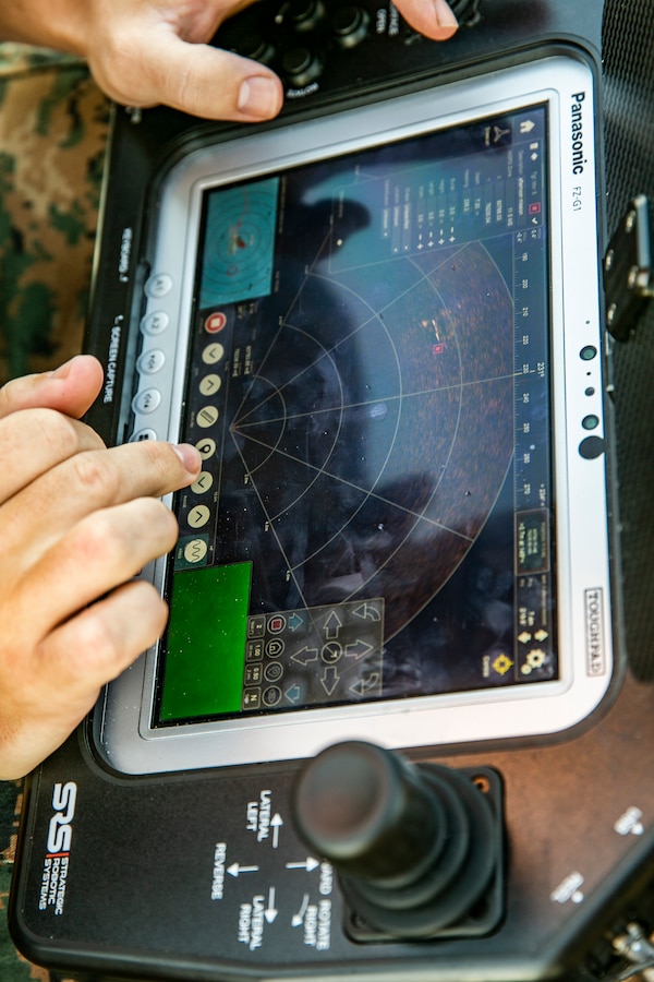 U.S. Marine Corps Sgt. Nathan Kijowski, an explosive ordnance disposal technician with 9th Engineer Support Battalion, 3d Marine Logistics Group, monitors a Fusion Strategic Robotics System during a littoral mobility and detection exercise on Camp Pendleton, California, Nov. 18, 2021. Combat engineers with Littoral Engineer Reconnaissance Team and explosive ordnance disposal technicians with the Littoral Explosive Ordnance Neutralization team conducted an exercise to test the integration of light detection and ranging technologies for the reconnaissance of shallow water to land route clearing in support of amphibious operations. During this exercise, 7th and 9th ESB are refining their skills with emerging Marine Corps technologies in order to facilitate follow-on forces’ littoral mobility from shallow water to the objective. (U.S. Marine Corps photo by Sgt. Hailey D. Clay)