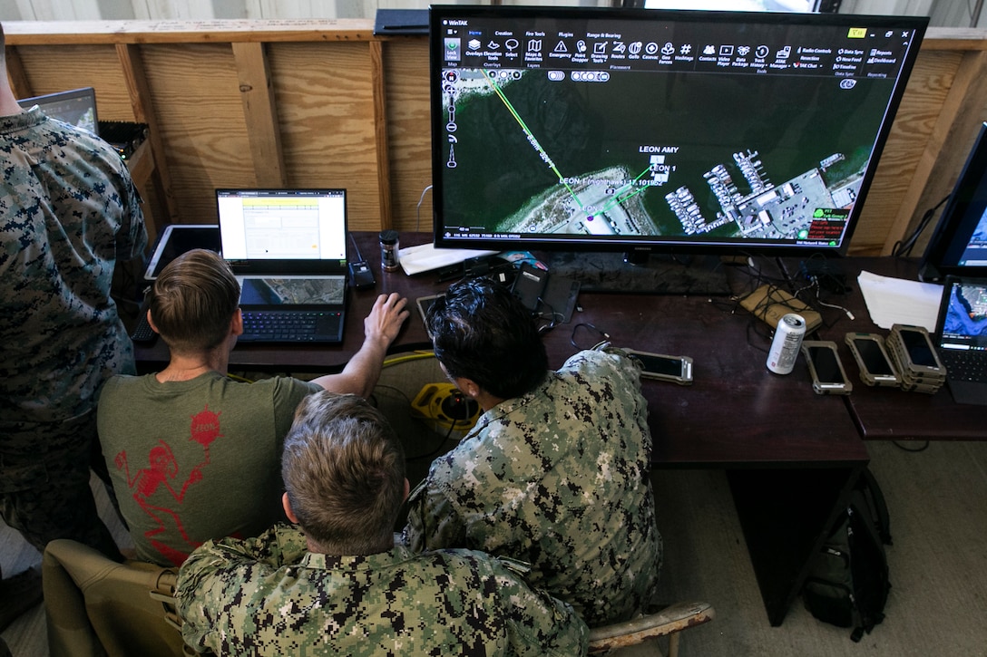 U.S. Marine Corps Staff Sgt. Paul Butcher, left, Littoral Explosive Ordnance Neutralization element leader with 7th Engineer Support Battalion, 1st Marine Logistics Group, utilizes the Windows Tactical Assault Kit system during a littoral mobility and detection exercise on Camp Pendleton, California, Nov. 18, 2021. Combat engineers with Littoral Engineer Reconnaissance Team and explosive ordnance disposal technicians with the Littoral Explosive Ordnance Neutralization team conducted an exercise to test the integration of light detection and ranging technologies for the reconnaissance of shallow water to land route clearing in support of amphibious operations. During this exercise, 7th and 9th ESB are refining their skills with emerging Marine Corps technologies in order to facilitate follow-on forces’ littoral mobility from shallow water to the objective. (U.S. Marine Corps photo by Sgt. Hailey D. Clay)