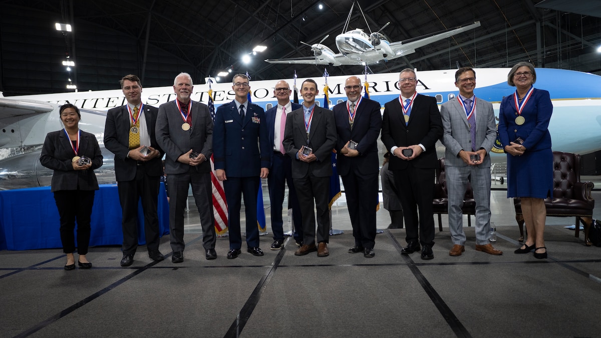 Seven Air Force Research Laboratory, or AFRL, Fellows stand with Brig. Gen. Scott A. Cain, fourth from left, AFRL commander, and Dr. Timothy J. Bunning, fifth from left, AFRL chief technology officer, Oct. 25, 2023. The honorees were recognized for their outstanding career accomplishments during the 2023 Fellows and ECA ceremony. Note: Dr. Stephen M. White is not pictured. (U.S. Air Force photo / Keith Lewis)