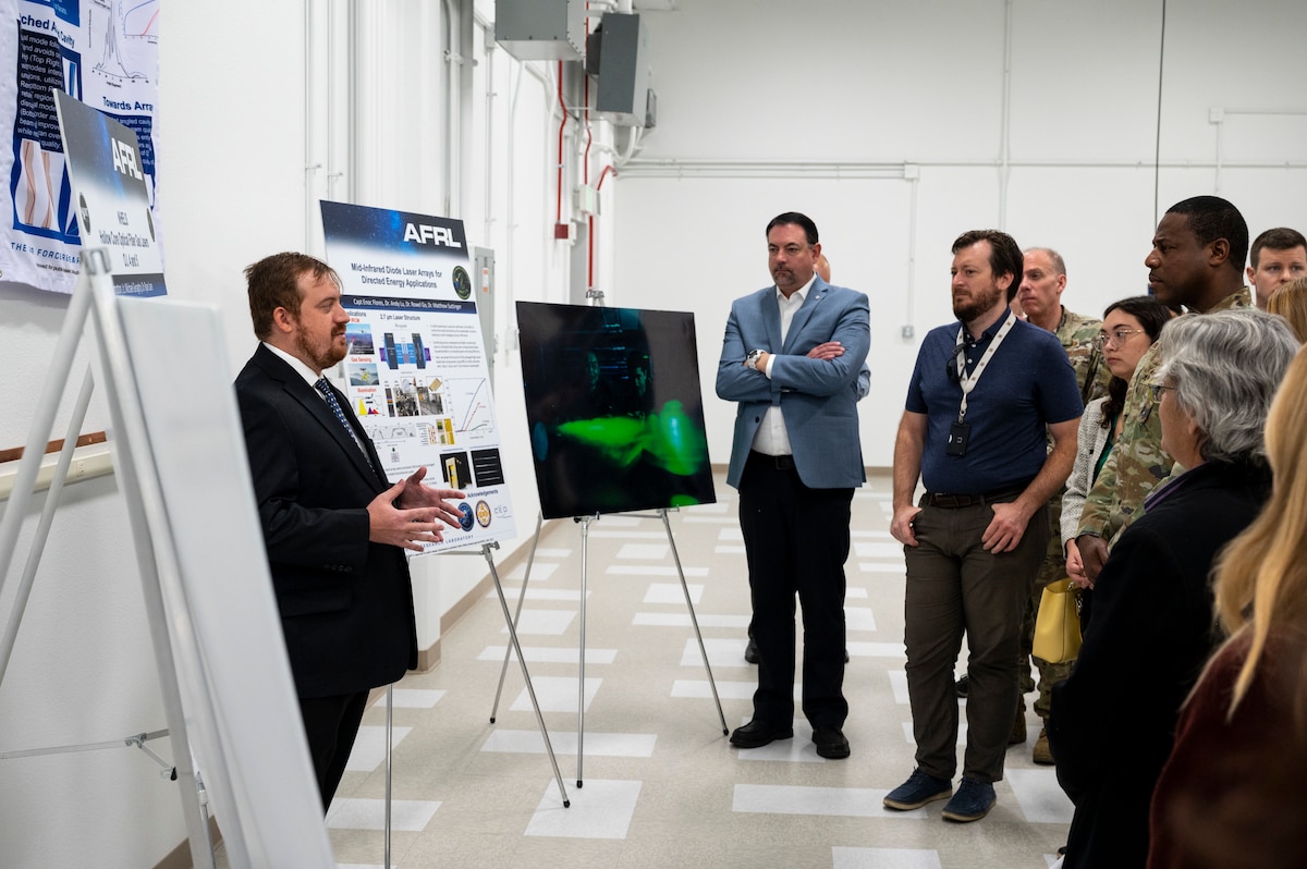 Matthew Suttinger, left, Air Force Laboratory directed energy acting principal investigator, briefs members and supporters of the Air Force Laboratory about the work in the Semiconductor Laser Indoor Propagation Range at Kirtland Air Force Base, N.M., Oct. 17, 2023. AFRL conducted a ribbon cutting ceremony for their new laser range that will serve to aid in propagations studies to fill in critical technology gaps. (U.S. Air Force photo / Airman 1st Class Ruben Garibay)