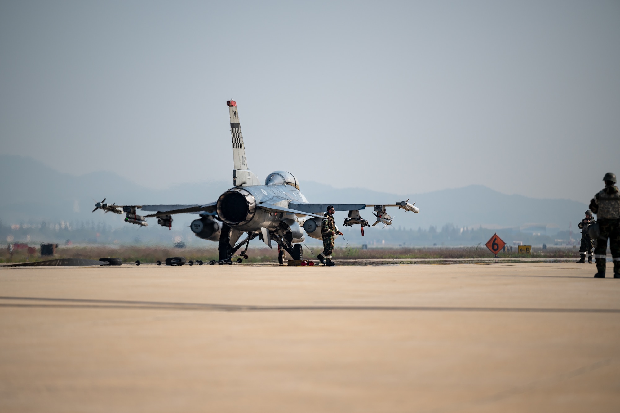 A U.S. Air Force F-16 Fighting Falcon stops on an alternate landing strip using a Mobile Aircraft Arresting System during Vigilant Defense 24 at Osan Air Base, Republic of Korea, Oct. 30, 2023. In contingency environments, the ALS is activated when the main runway sustains heavy damage, which allows pilots to maintain readiness and continue flying operations. VD24 is a routine training event that tests the military capabilities across the peninsula, allowing combined and joint training at both the operational and tactical levels. (U.S. Air Force photo by Staff Sgt. Thomas Sjoberg)