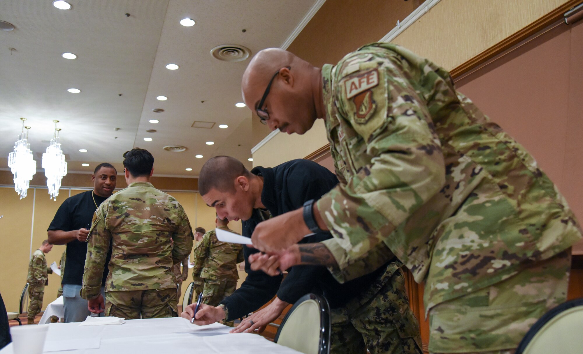 Airmen and sailors participating in a professional development.