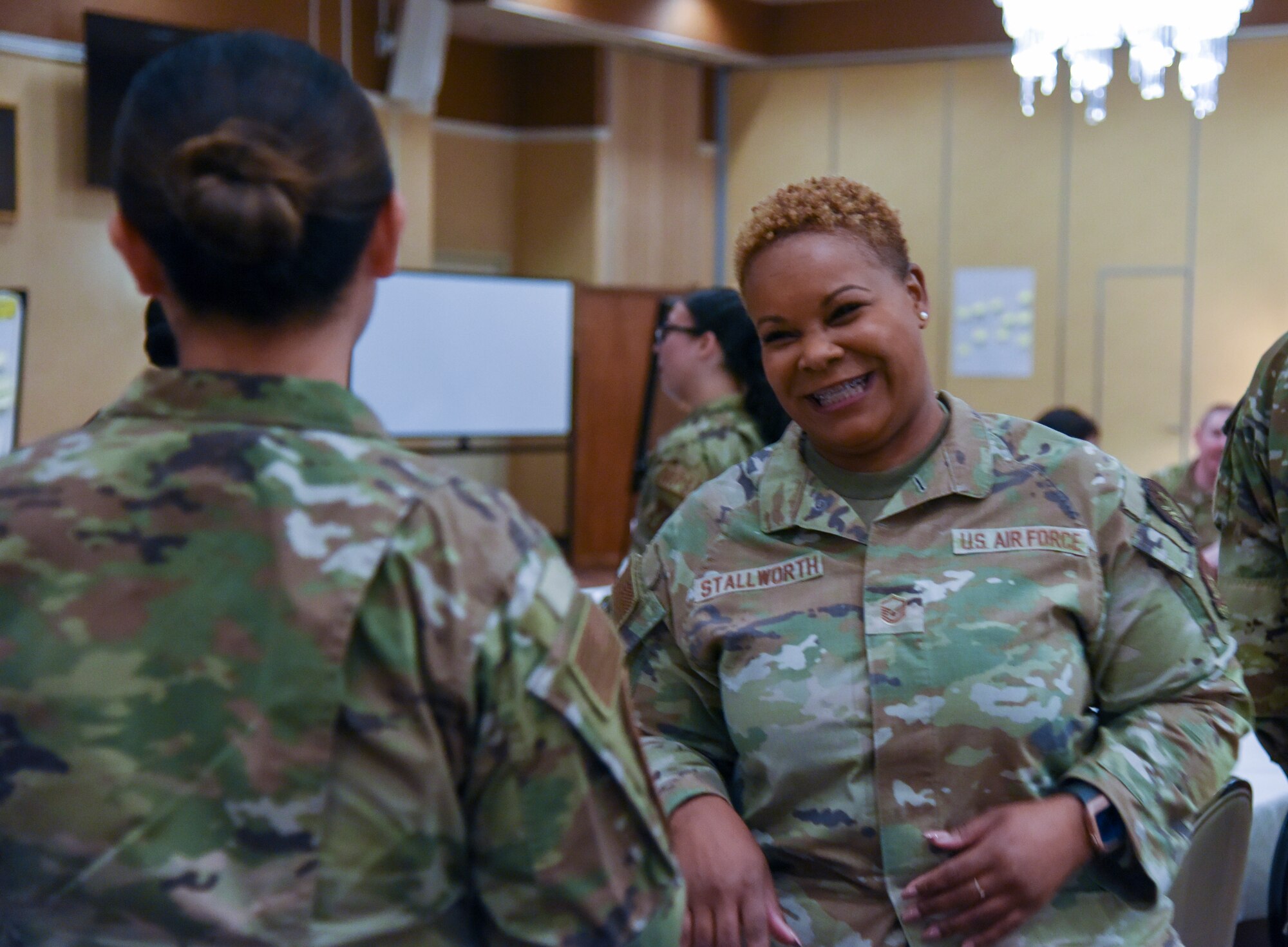 Airmen interact during a professional development event.