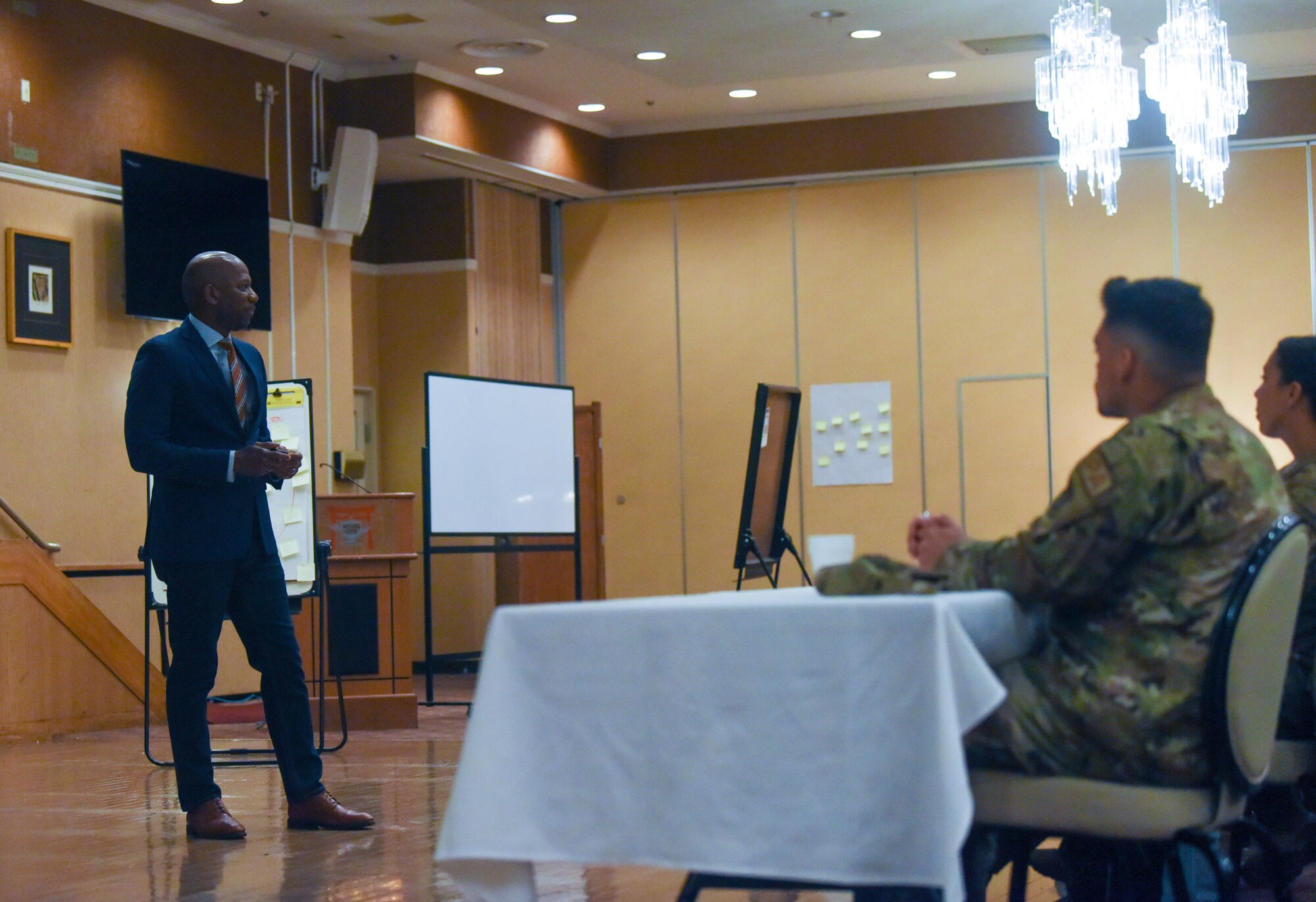 Briefer addresses Airmen during a professional development.