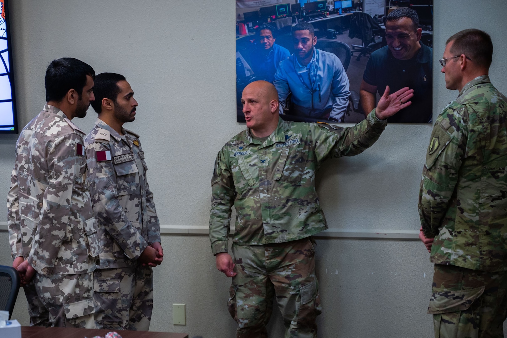 A U.S. Space Force Colonel talks with two Qatari Armed Forces members about Space Domain Awareness.