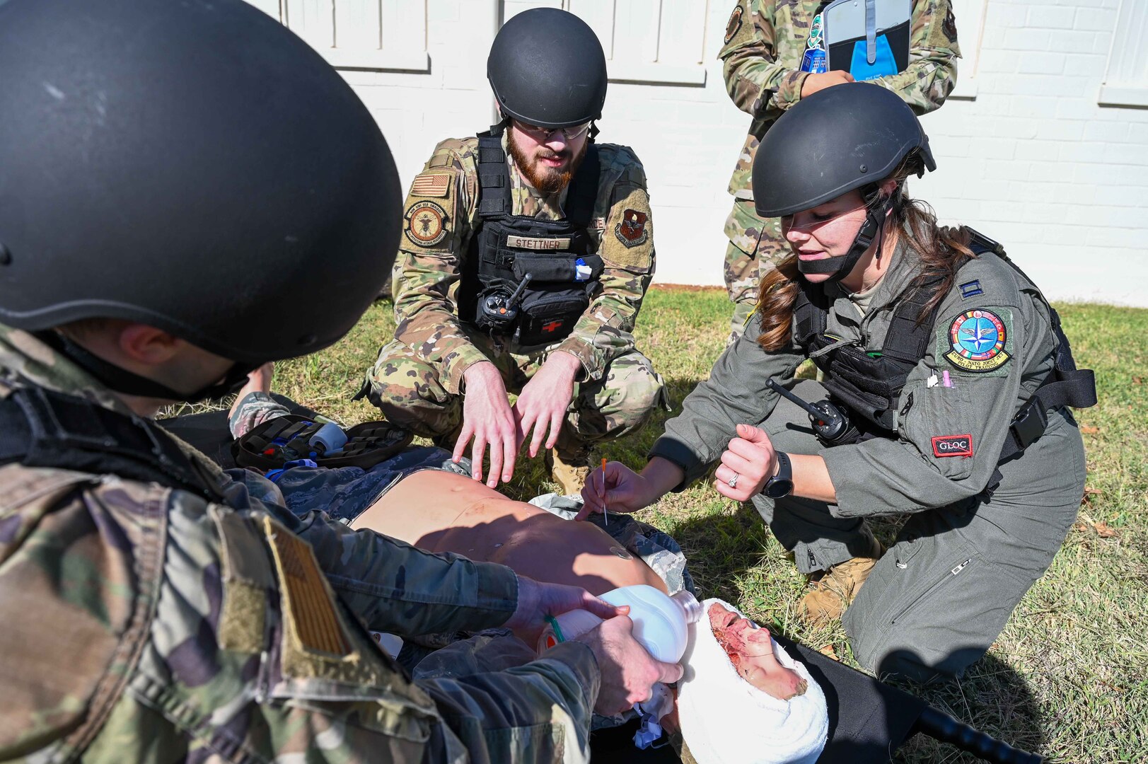 U.S. Air Force Capt. Alyssa Brown, 82nd Medical Group (MDG) flight surgeon, shows Airman 1st Class Ethan Stettner, 97th MDG dental technician, how to do a needle thoracostomy on a mannequin during the Caduceus Spear exercise at Clinton Sherman Airfield Park, Oklahoma, Oct. 26, 2023. Leaders from the 97th MDG intended to utilize both medics and non-medics to safely transport injured individuals to a higher level of care facility while providing critical first aid by Tactical Combat Casualty Care and MEDIC-X training. (U.S. Air Force photo by Airman 1st Class Kari Degraffenreed)