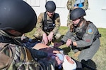 U.S. Air Force Capt. Alyssa Brown, 82nd Medical Group (MDG) flight surgeon, shows Airman 1st Class Ethan Stettner, 97th MDG dental technician, how to do a needle thoracostomy on a mannequin during the Caduceus Spear exercise at Clinton Sherman Airfield Park, Oklahoma, Oct. 26, 2023. Leaders from the 97th MDG intended to utilize both medics and non-medics to safely transport injured individuals to a higher level of care facility while providing critical first aid by Tactical Combat Casualty Care and MEDIC-X training. (U.S. Air Force photo by Airman 1st Class Kari Degraffenreed)