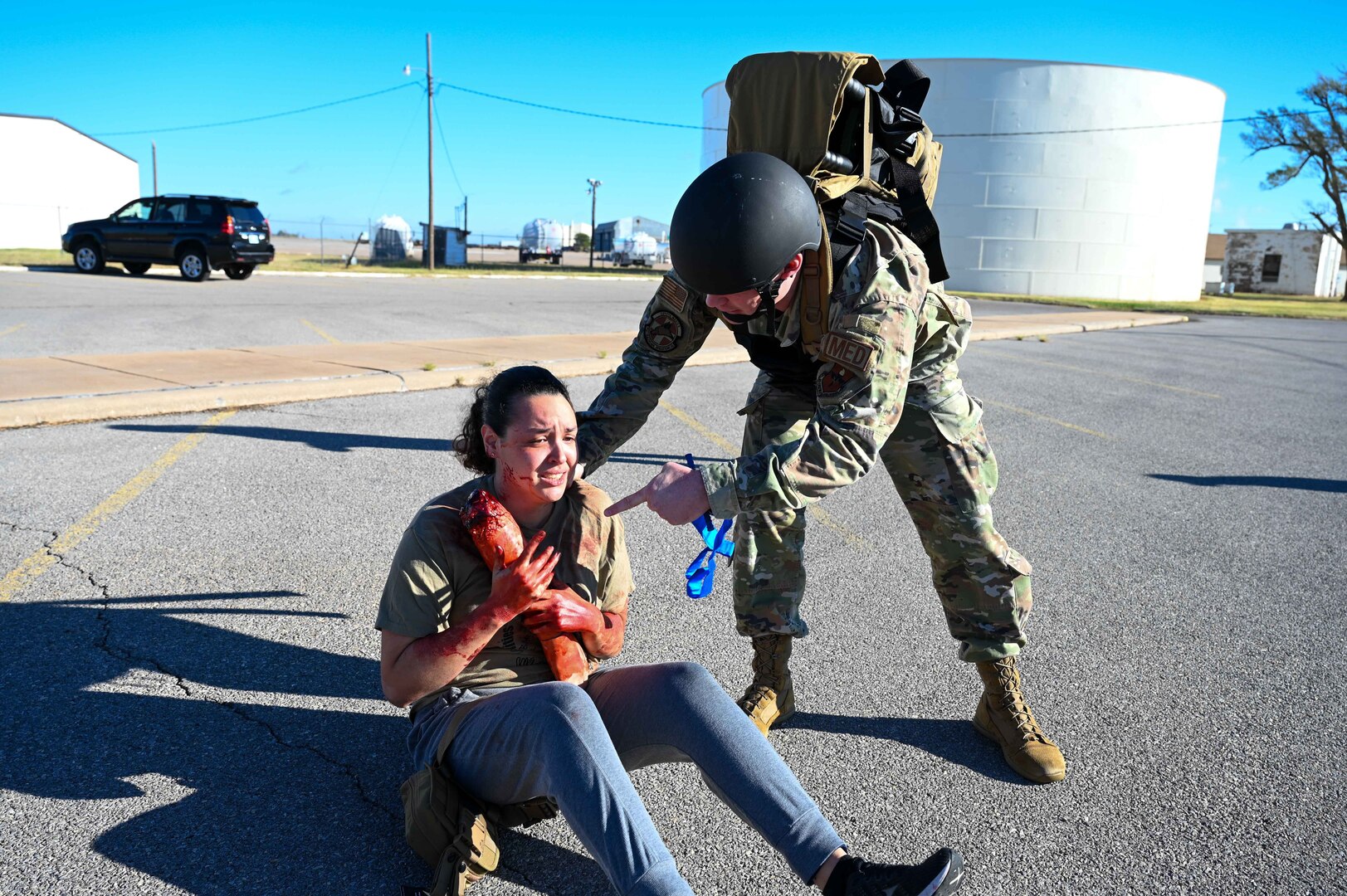 U.S. Air Force Tech. Sgt. Robert Thorne, 71st Medical Group diagnostic and therapeutics flight chief, assists a patient during the Caduceus Spear exercise at Clinton Sherman Airfield Park, Oklahoma, Oct. 26, 2023. The real life patients were actors from the 97th Medical Group who were tasked with giving realistic responses to the Airmen assisting them. (U.S. Air Force photo by Airman 1st Class Kari Degraffenreed)