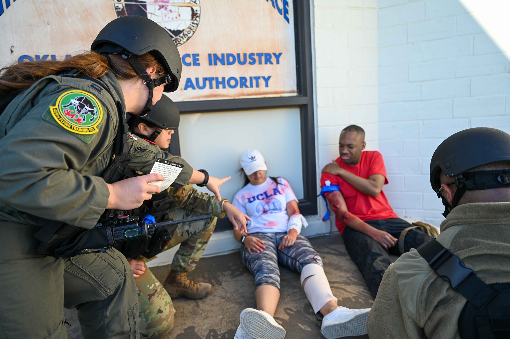 U.S. Air Force Capt. Alyssa Brown, 82nd Medical Group flight surgeon, explains how to write up identification cards for injured patients to Airmen during the Caduceus Spear exercise at Clinton Sherman Airfield Park, Oklahoma, Oct. 26, 2023. Participants in the exercise were a mix of medics and non-medics, to ensure all Airmen involved would receive training in life-saving skills before air evacuation can arrive. (U.S. Air Force photo by Airman 1st Class Kari Degraffenreed)