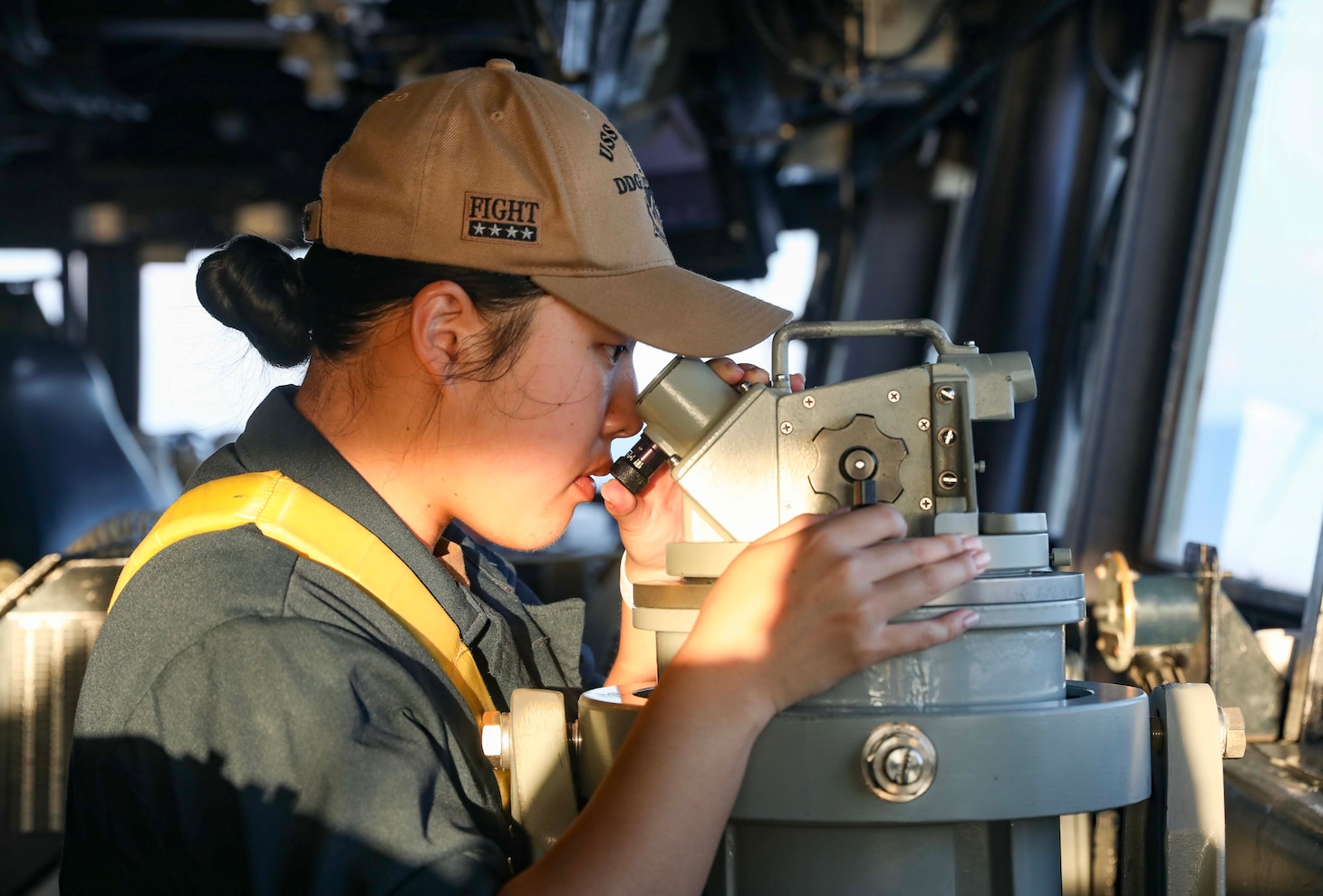 SOUTH CHINA SEA (Nov. 3, 2023) – Ensign Nicole Choi, from Paramus, New Jersey, looks through a telescopic alidade on the bridge as the Arleigh Burke-class guided-missile destroyer USS Dewey (DDG 105) conducts routine underway operations. Dewey is forward-deployed and assigned to Commander, Task Force 71/Destroyer Squadron (DESRON) 15, the Navy’s largest DESRON and the U.S. 7th Fleet’s principal surface force. (U.S. Navy photo by Mass Communication Specialist 1st Class Greg Johnson)