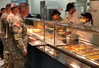 Soldiers from the 55th Quartermaster Company serve up lunch at the Knight’s Lair Warrior Restaurant, Nov. 3. The Knight’s Lair staff is made up of local national employees and Army civilians from Logistics Readiness Center Rheinland-Pfalz, contractors, and culinary specialists from the 55th QM Company.