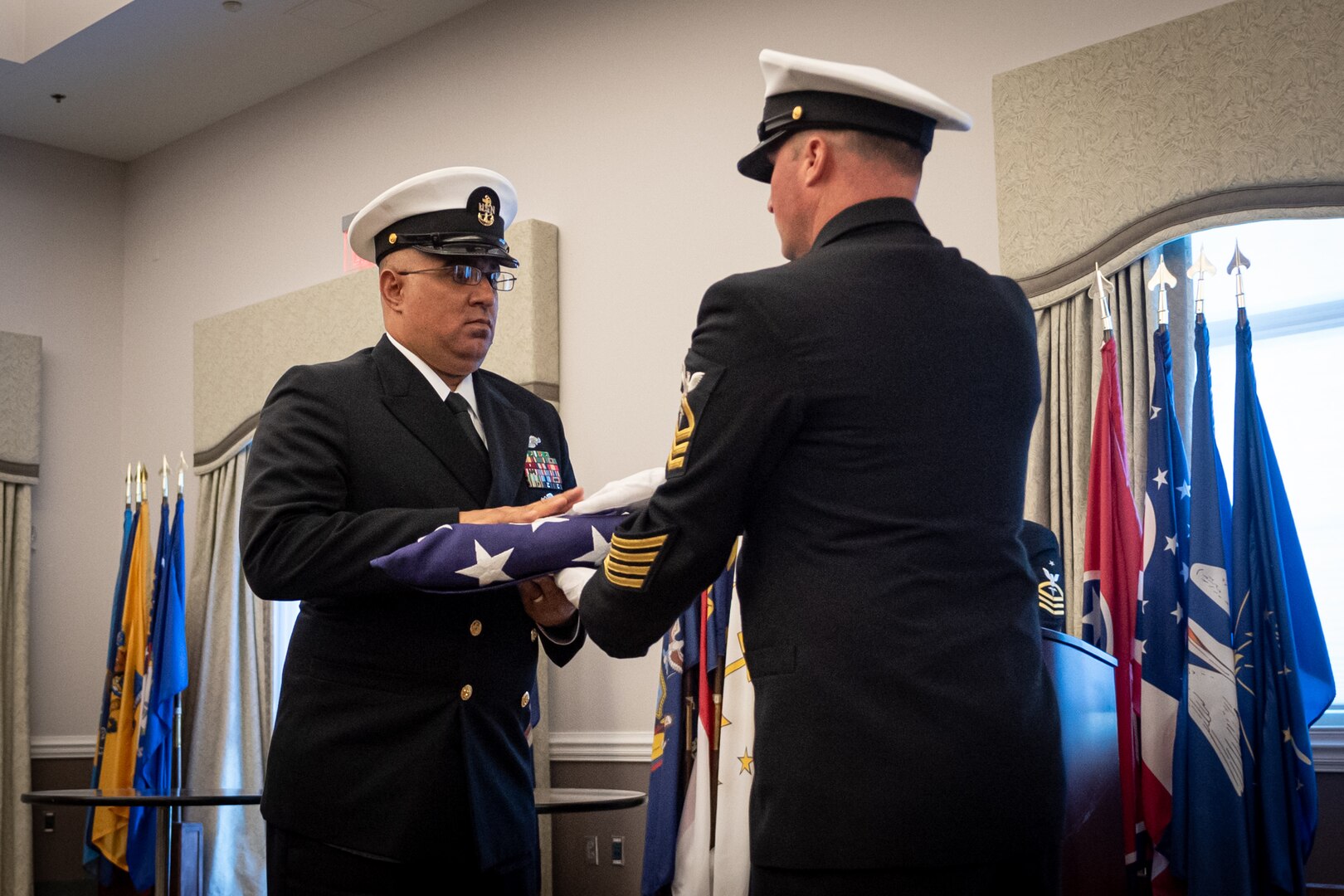 Chief Hospital Corpsman Felix Colon (Fleet Marine Force / Enlisted Expeditionary Warfare Specialist) accepts the flag of the United States of America as a token of his faithful 23 years of service to the nation during a ceremony held Thursday, November 2, 2023 aboard Marine Corps Air Station Cherry Point.  Colon retired during the ceremony, ending his service as the Senior Enlisted Leader for the Directorate of Clinical Support Services and Directorate of Medical Services at Naval Health Clinic Cherry Point.