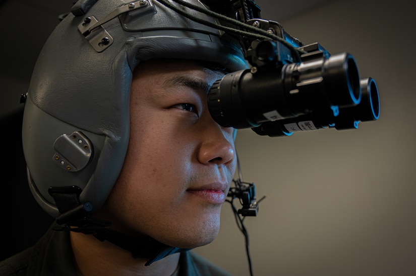 U.S. Air Force Capt. Victor Lee, 2nd Air Refueling Squadron pilot, dons night vision goggles during the Neptune Series at Travis Air Force Base, Calif., Oct. 24, 2023. This joint air interoperability exercise is the first-ever certification event for the KC-46A Pegasus tankers assigned to Joint Base McGuire-Dix-Lakehurst, N.J. (U.S. Air Force photo by Airman 1st Class Simonne Barker)