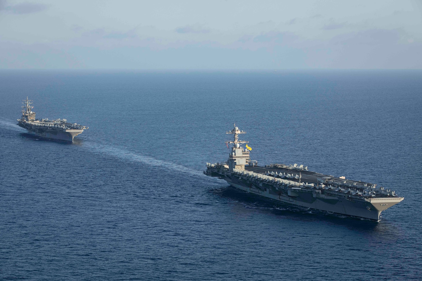 231103-N-LK647-1272 EAST MEDITERRANEAN SEA (Nov. 3, 2023) The world’s largest aircraft carrier USS Gerald R. Ford (CVN 78) steams in formation with the Nimitz-class aircraft carrier USS Dwight D. Eisenhower (CVN 69) during a photo exercise, Nov. 3, 2023. Normandy is part of the Gerald R. Ford Carrier Strike Group and is currently operating in the East Mediterranean Sea, at the direction of the Secretary of Defense. The U.S. maintains forward-deployed, ready, and postured forces to deter aggression and support security and stability around the world. (U.S. Navy photo by Mass Communication Specialist 2nd Class Malachi Lakey)