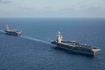 231103-N-LK647-1272 EAST MEDITERRANEAN SEA (Nov. 3, 2023) The world’s largest aircraft carrier USS Gerald R. Ford (CVN 78) steams in formation with the Nimitz-class aircraft carrier USS Dwight D. Eisenhower (CVN 69) during a photo exercise, Nov. 3, 2023. Normandy is part of the Gerald R. Ford Carrier Strike Group and is currently operating in the East Mediterranean Sea, at the direction of the Secretary of Defense. The U.S. maintains forward-deployed, ready, and postured forces to deter aggression and support security and stability around the world. (U.S. Navy photo by Mass Communication Specialist 2nd Class Malachi Lakey)