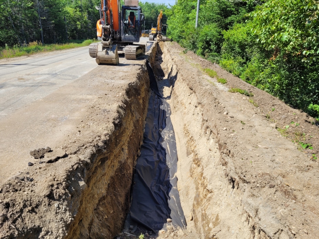 The contractor digs a trench to run the waterline.