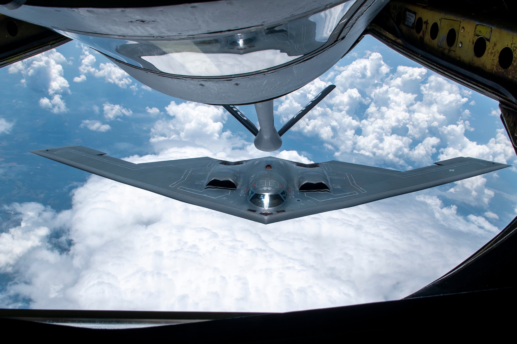 A KC-135 Stratotanker from the 121st Air Refueling Wing refuels a Northrop Grumman B-2 Spirit over the skies of Missouri, June 7, 2023. The KC-135 enables the B-2, also known as the Stealth Bomber, to bring massive firepower to bear, in a short time, anywhere on the globe through previously impenetrable defenses. (U.S. Air National Guard Photo by Airman First Class Ivy Thomas)