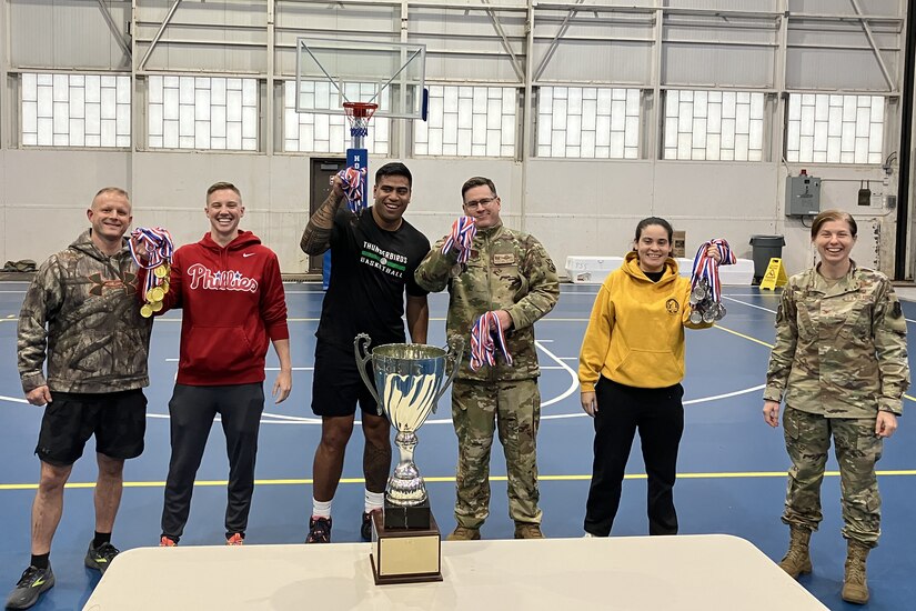 U.S. Air National Guard Col. Lynn Lee, far right, 111th Attack Wing Commander, presents the 111th ATKW Commander's Cup medals to members of the Wing here on Oct. 14, 2023. The Commander's Cup, which consisted of tug of war, a sprint medley, pull ups, volleyball, basketball, corn hole and weightlifting, is an event designed to promote camaraderie while highlighting resilience and physical fitness. (U.S. Air National Guard Photo by Staff Sgt. Wil Acosta)