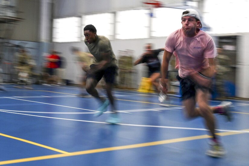 Members of the Pennsylvania Air National Guard's 111th Attack Wing participate in a shuttle relay during 111th ATKW Commander's Cup competition at Biddle Air National Guard Base in Horsham, Pennsylvania, Oct. 14, 2023. The Commander's Cup, which consisted of tug of war, a sprint medley, pull ups, volleyball, basketball, corn hole and weightlifting, is an event designed to promote camaraderie while highlighting resilience and physical fitness. (U.S. Air National Guard Photo by Staff Sgt. Ben McMahon)