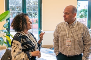 Marianne Malizia and Dr. Andrew Duffield exchange insights and ideas during an intermission at the Gartner ReimagineHR Conference Oct. 23-25, 2023, in Orlando, Fla. The three-day conference provided attendees the opportunity to hear keynotes and attend breakout sessions pertaining to SAF/DI's ongoing commitment to enhancing diversity, equity, inclusion and accessibility initiatives within the Department of the Air Force. Malizia is the Secretary of the Air Force Diversity and Inclusion director, and Duffield is the SAF/DI Strategy, Policy and Governance Division program manager. (U.S. Air Force photo by Capt. Shane Ellis)