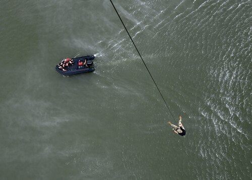 U.S. Air Force Senior Enlisted Advisor to the Chairman Ramón “CZ” Colón-López, hoists into a boat during a pararescue demonstration in Louisville, Ky., Sept. 6, 2023. The 563rd Rescue Group provided supporting assets to the demonstration. The 563rd RQG directs flying operations for the one of the Air Force’s only active-duty rescue wings dedicated to combat search and rescue. (U.S. Air Force photo by Staff Sgt. Abbey Rieves)
