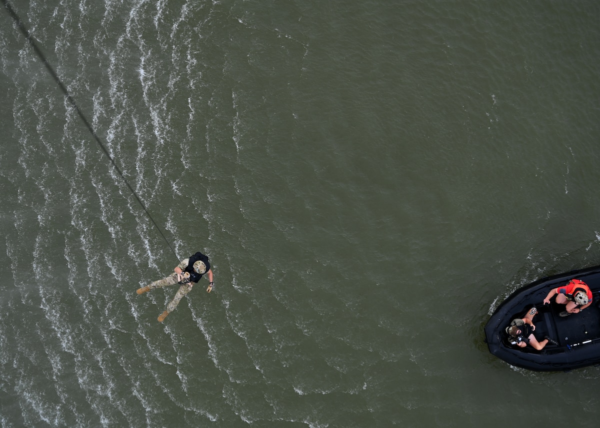 U.S. Air Force Senior Enlisted Advisor to the Chairman Ramón “CZ” Colón-López, hoists into a boat during a pararescue demonstration in Louisville, Ky., Sept. 6, 2023. The 563rd Rescue Group provided supporting assets to the demonstration. The 563rd RQG directs flying operations for the one of the Air Force’s only active-duty rescue wings dedicated to combat search and rescue. (U.S. Air Force photo by Staff Sgt. Abbey Rieves)