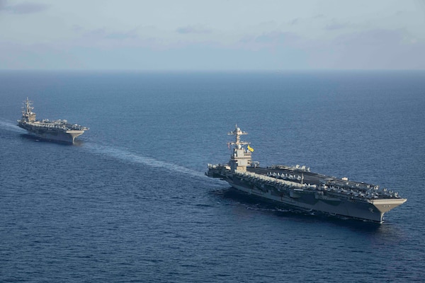 231103-N-LK647-1272 EAST MEDITERRANEAN SEA (Nov. 3, 2023) The world’s largest aircraft carrier USS Gerald R. Ford (CVN 78) steams in formation with the Nimitz-class aircraft carrier USS Dwight D. Eisenhower (CVN 69) during a photo exercise, Nov. 3, 2023. Normandy is part of the Gerald R. Ford Carrier Strike Group and is currently operating in the East Mediterranean Sea, at the direction of the Secretary of Defense. The U.S. maintains forward-deployed, ready, and postured forces to deter aggression and support security and stability around the world. (U.S. Navy photo by Mass Communication Specialist 2nd Class Malachi Lakey)