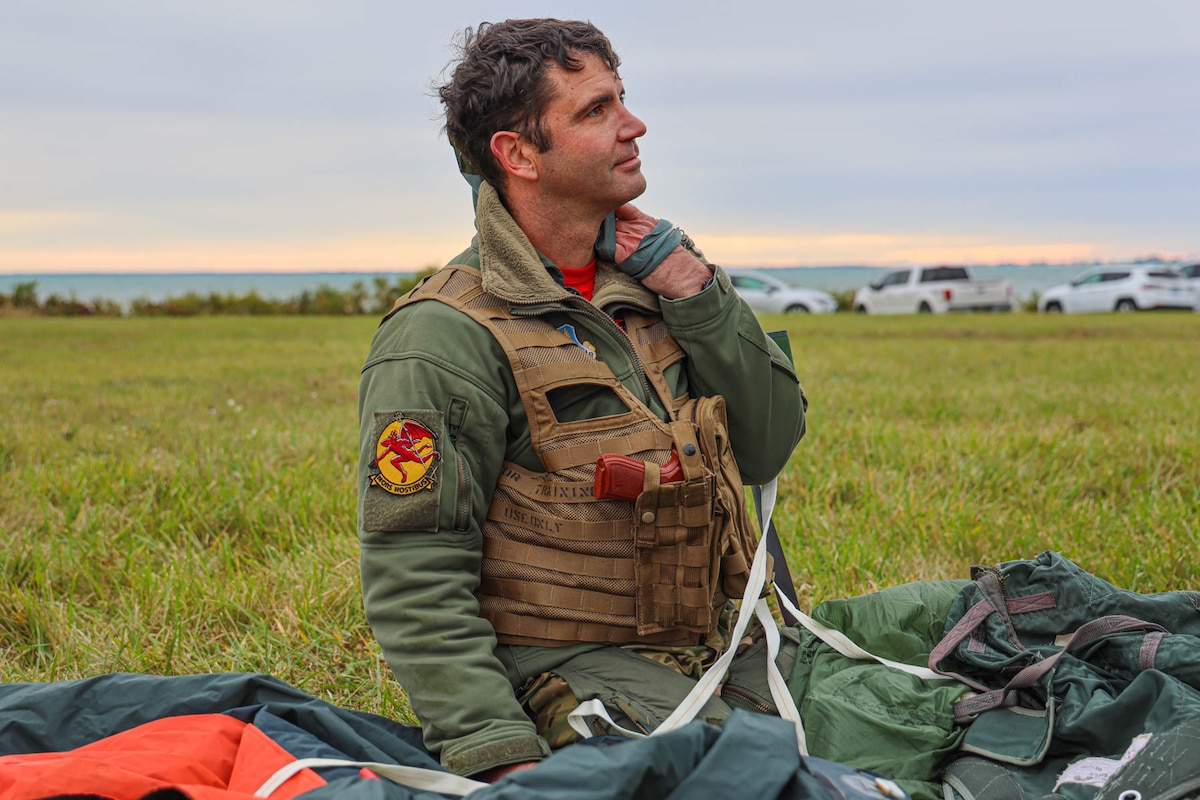 Lt. Col. Adam Pauly, 107th Fighter Squadron commander, Michigan Air National Guard, practices disengaging from parachute equipment during training. Over the October 2023 drill at Selfridge Air National Guard Base, Michigan, pilots participated in a survival, evasion, resistance and escape training refresher course.