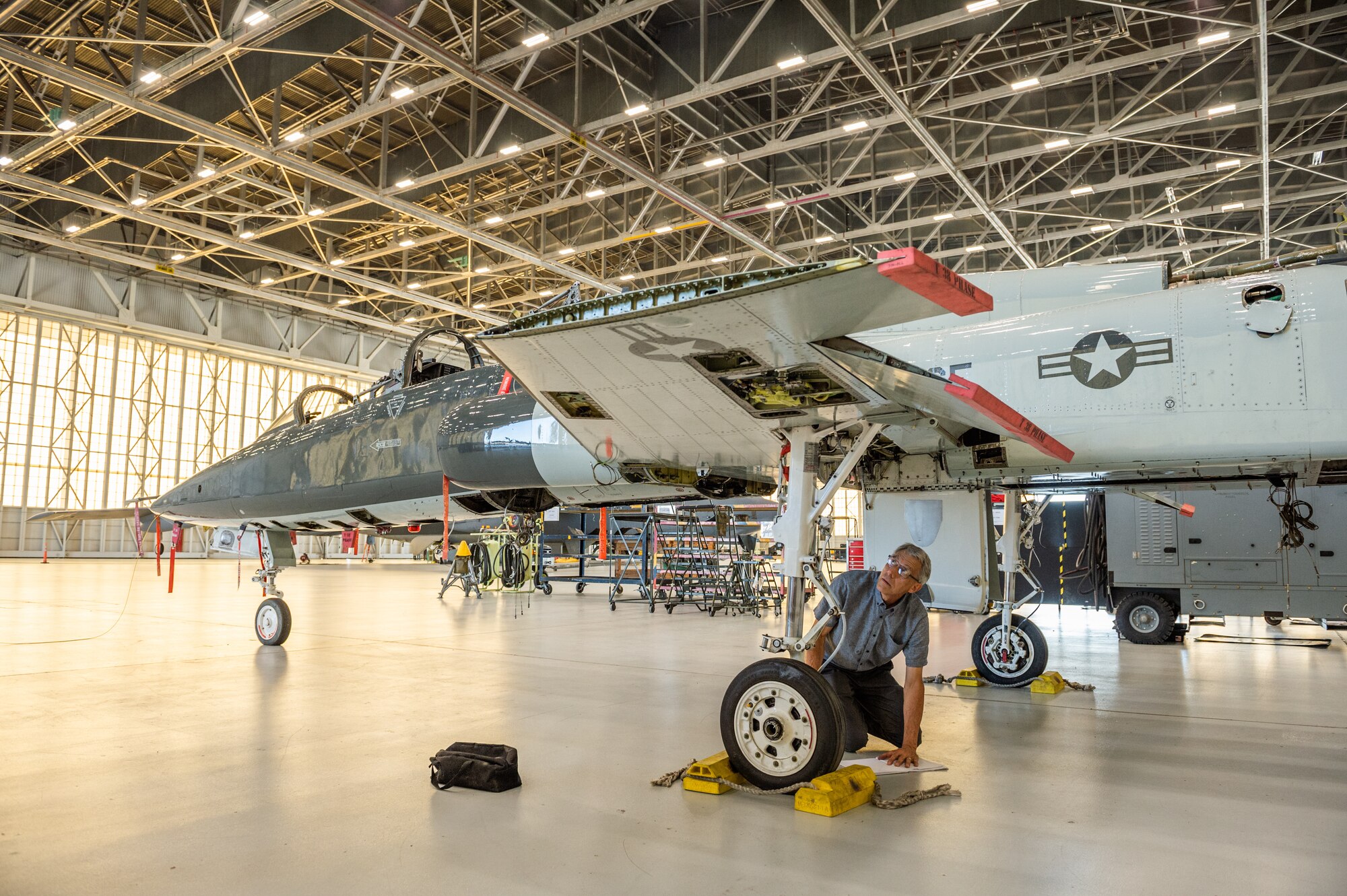 Rick Choate, Exosonic, Inc. chief engineer, obtains measurements from a T-38 Talon II aircraft at Edwards Air Force Base, California, Aug. 29. The measurements will aid Exosonic in the development a next generation aerial target for the Air Force.