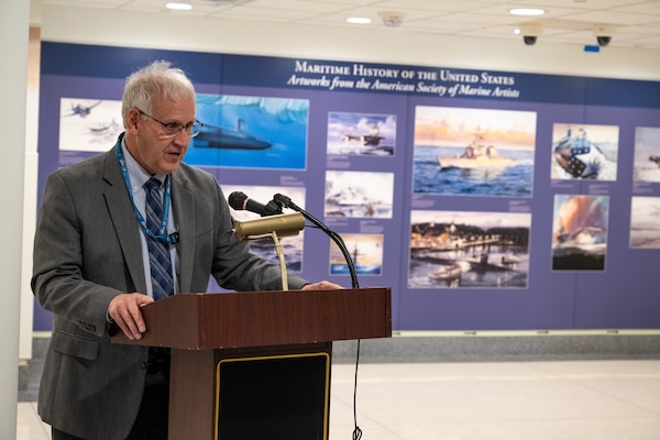 A man stands at a lectern.