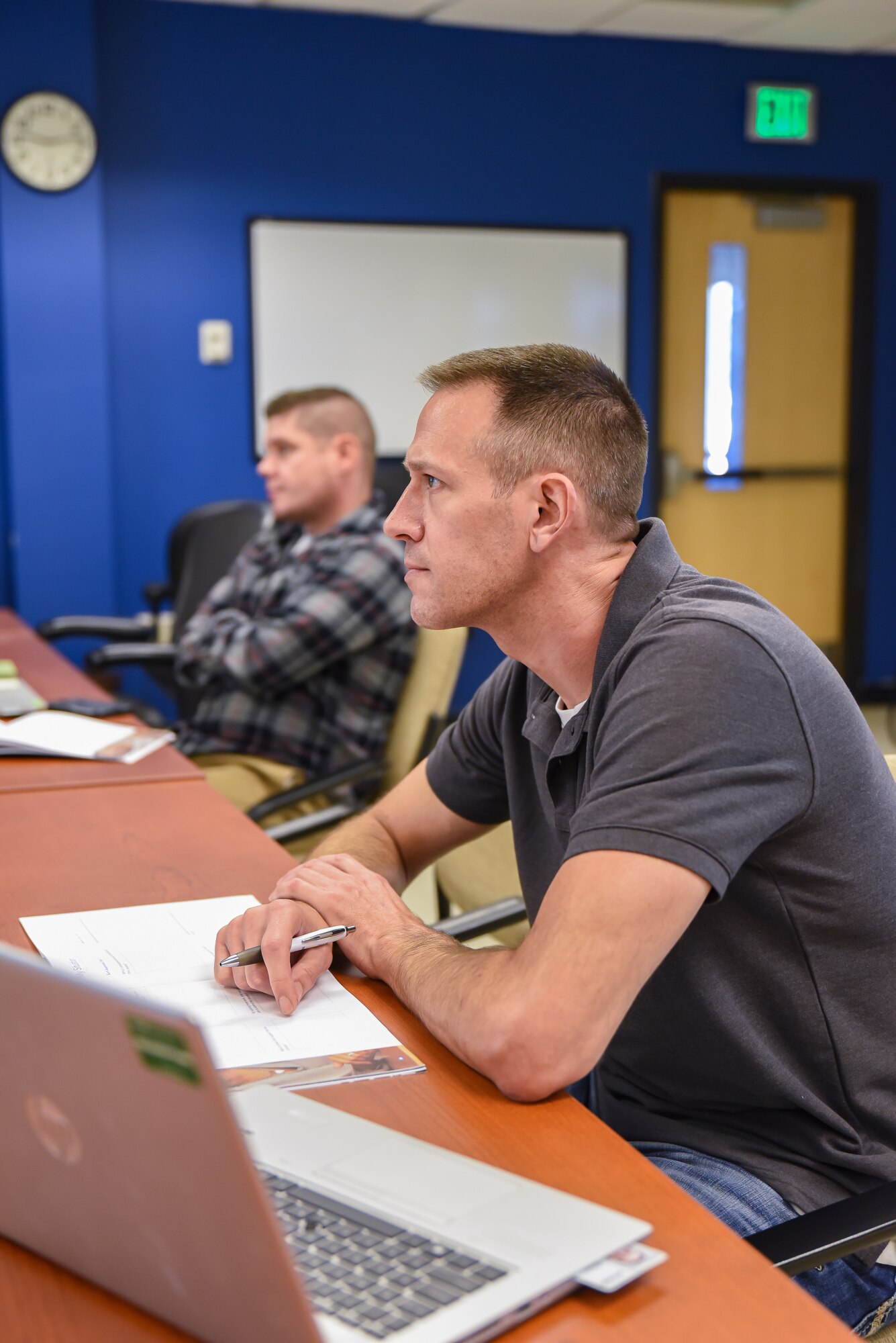 An U.S. Air Force member sits in a classroom and participates in leadership training.