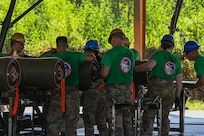 Airmen from the 2nd Munitions Squadron install fuzes into the tails of BLU-109 bomb bodies during the Global Strike Challenge Sep. 7, 2023 at Barksdale Air Force Base, La. Each GSC team was evaluated on their performance in events that require teamwork, efficiency, and innovative thinking.(U.S. Air Force photo by Airman 1st Class Seth Watson)