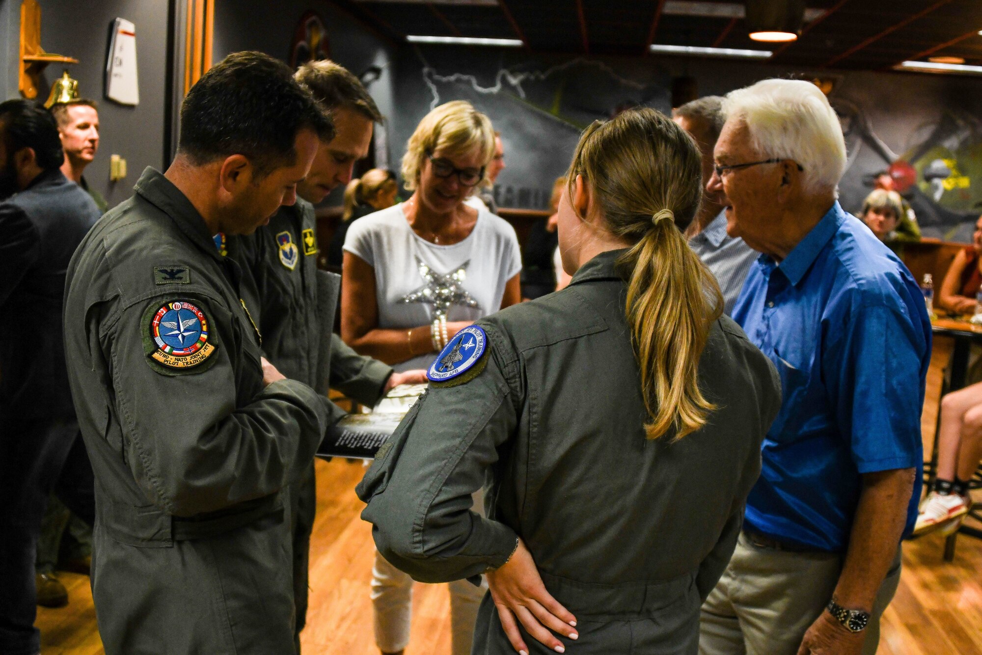 Col. Brad Orgeron, 80th Flying Training Wing commander, receives a photo book of Ankang Airfield from the grandfather of a Norwegian pilot graduate at the Euro-NATO Joint Jet Pilot Training (ENJJPT) program. (Courtesy Photo)
