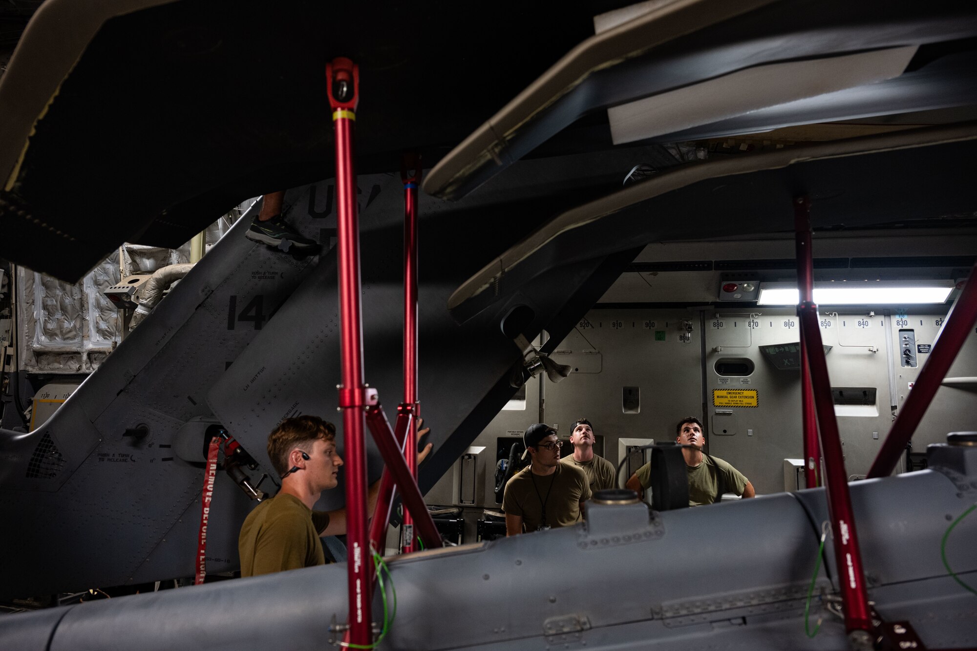 U.S. Airmen load a helicopter onto a cargo aircraft.