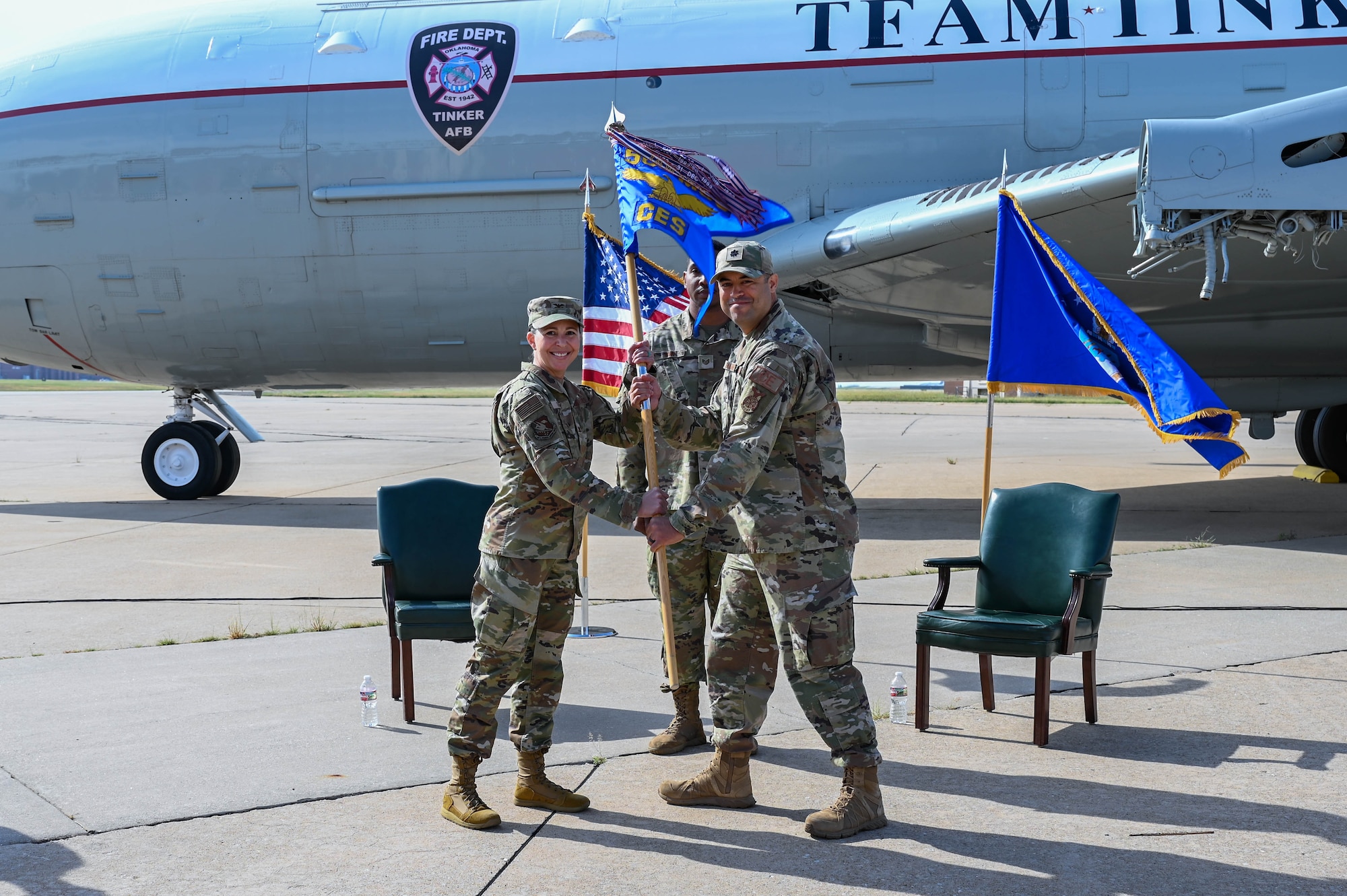 people holding a flag smiling at the camera