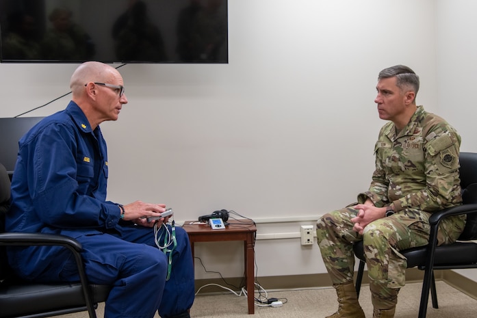 U.S. Public Health Service Lt. Cmdr. Brian Reiner, 628th Operational Medical Readiness Squadron mental health element lead, left, and Maj. Gen. John Klein, U.S. Air Force Expeditionary Center commander, engage in a discussion on mental health on Joint Base Charleston, South Carolina, Nov. 2, 2023.