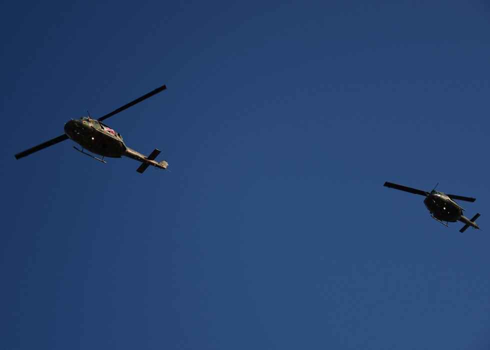Two UH-1N Huey helicopters fly over the LeGrande Stadium during The Star-Spangled Banner for Military Appreciation Day at Angelo State University, San Angelo, Texas, Nov. 4, 2023. The Hueys were part of a static display at Ram Jam and brought veterans, civilians and active duty together. (U.S. Air Force photo by Staff Sgt. Nathan Call)