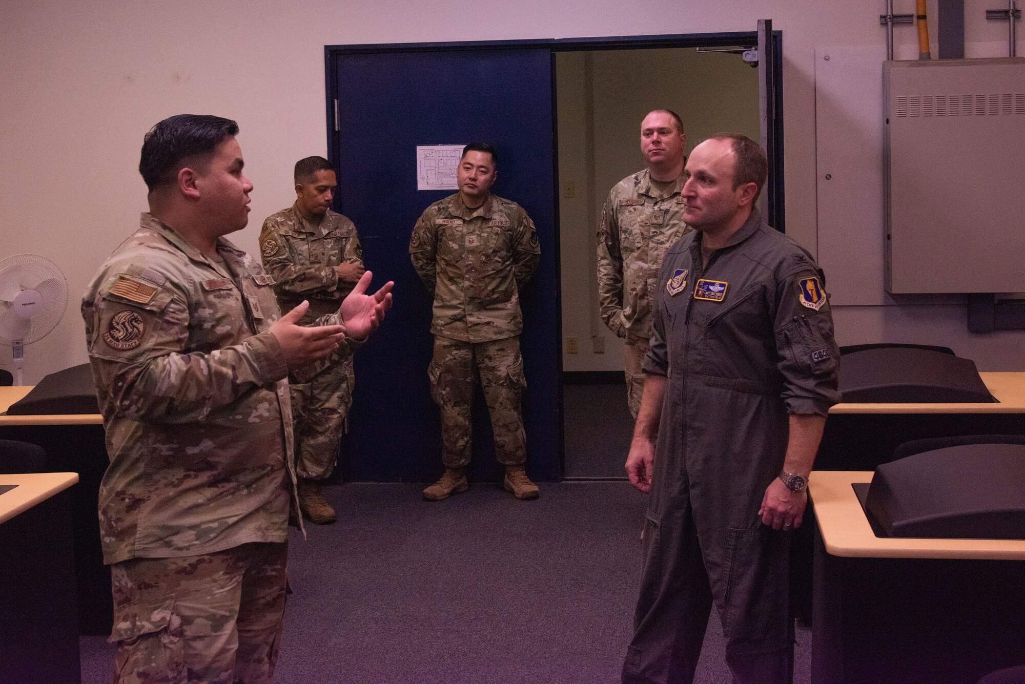 U.S. Air Force Col. Matthew Kenkel, 35th Fighter Wing deputy commander, listen to an Airman assigned to the 35th Maintenance Squadron test, measurement, and diagnostic equipment flight (TMDE) during a Wild Weasel Walk-Through at Misawa Air Base, Japan, Oct. 26, 2023.