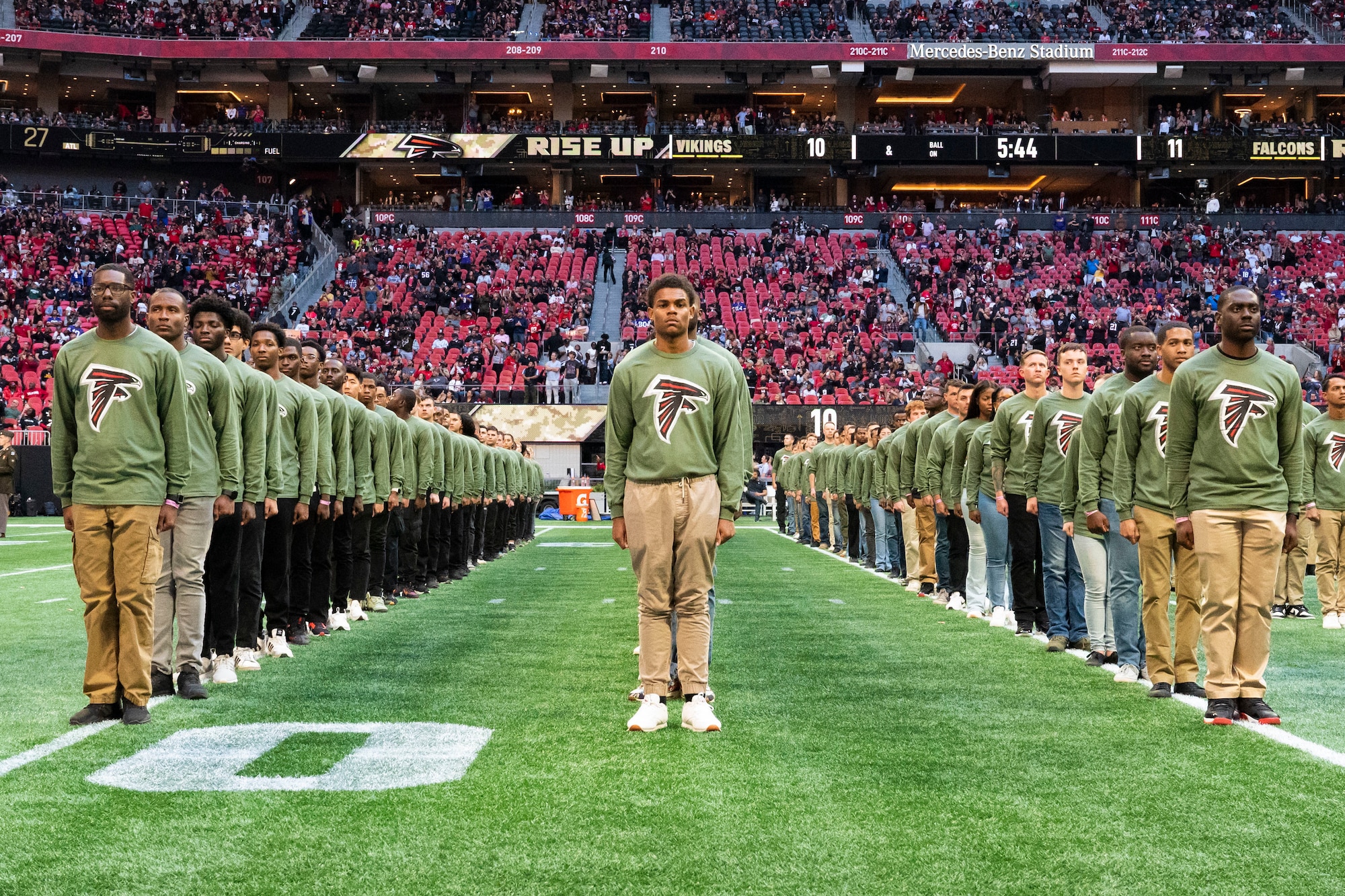 People stand on a football field.