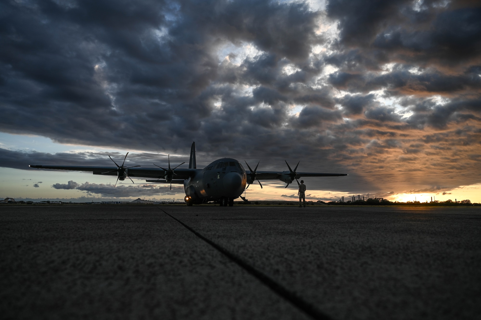 An aircraft sits in the flightline.