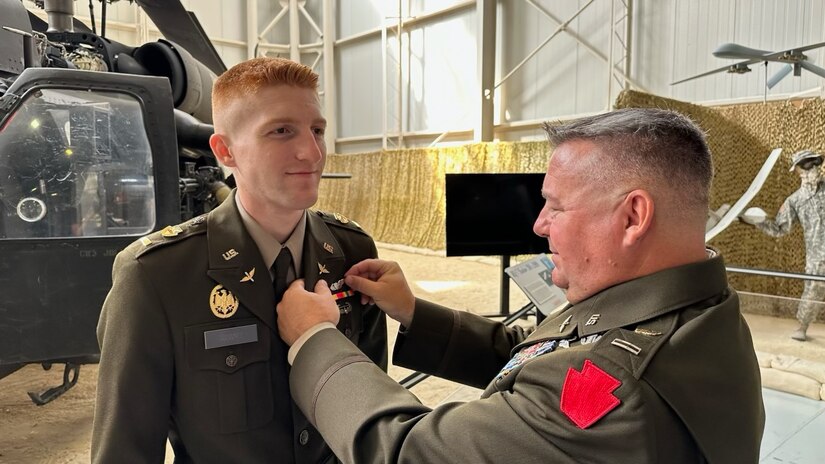 U.S. Army Chief Warrant Officer 5 Rich Adams pins aviator wings on his son, 2nd Lt. Zack Adams, upon his graduation from U.S. Army Initial Entry Rotary Wing school at Fort Novosel, Alabama, Oct. 5 2023. (Courtesy Photo)