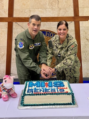 Colonel Thomas Cantilina, Defense Health Agency Chief Health Informatics Officer and Captain Kathleen Cooperman Commanding Officer of Naval Hospital Okinawa, cut a cake to celebrate the transition to MHS GENESIS.