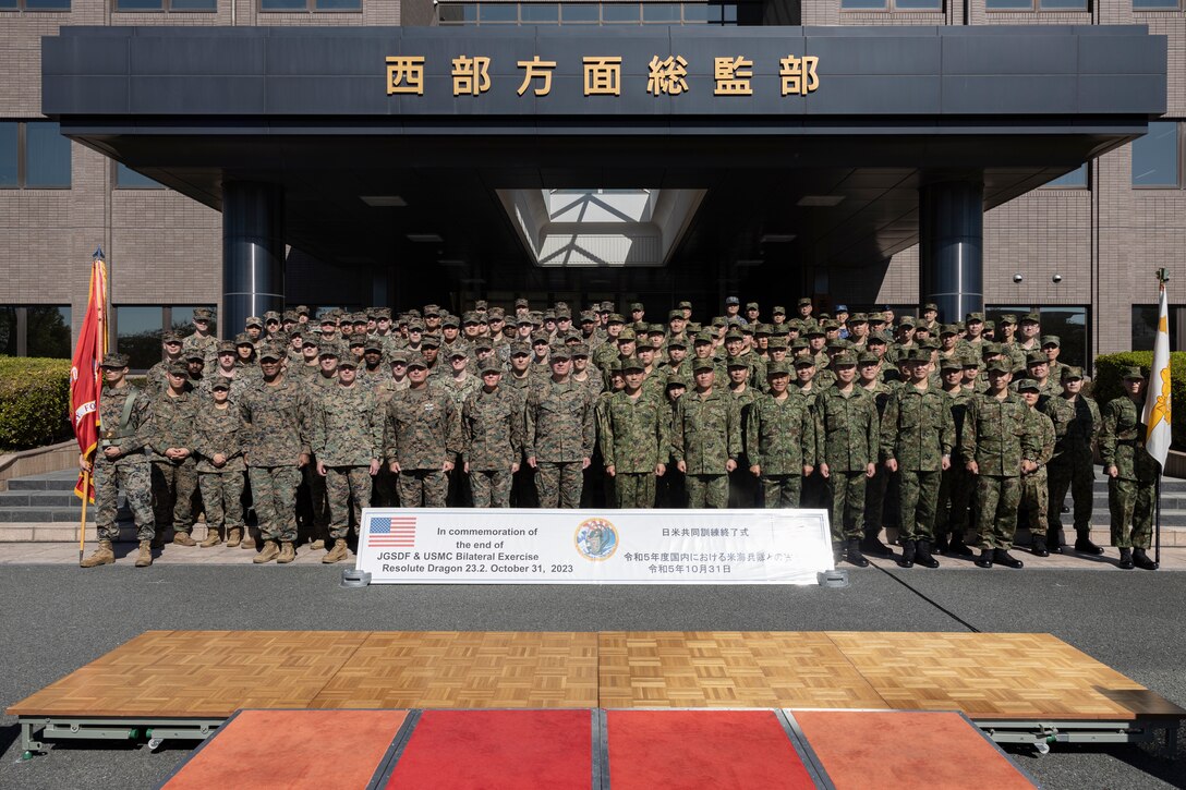 Members of the U.S. Armed Forces and Japan Self-Defense Force salute while in formation during the closing ceremony for the field training exercise portion of Resolute Dragon 23 held at Japan Ground Self-Defense Force Camp Kengun, Kumamoto, Japan, Oct. 31, 2023. RD 23 is an annual bilateral exercise in Japan that strengthens the command, control, and multi-domain maneuver capabilities of Marines in III Marine Expeditionary Force and allied JSDF personnel.