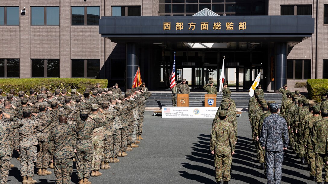 Members of the U.S. Armed Forces and Japan Self-Defense Force salute while in formation during the closing ceremony for the field training exercise portion of Resolute Dragon 23 held at Japan Ground Self-Defense Force Camp Kengun, Kumamoto, Japan, Oct. 31, 2023. RD 23 is an annual bilateral exercise in Japan that strengthens the command, control, and multi-domain maneuver capabilities of Marines in III Marine Expeditionary Force and allied JSDF personnel. (U.S. Marine Corps photo by Staff Sgt. Robert G. Gavaldon)