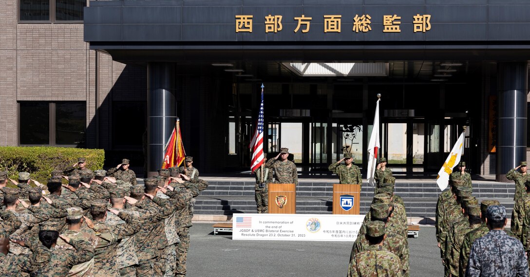 Members of the U.S. Armed Forces and Japan Self-Defense Force salute while in formation during the closing ceremony for the field training exercise portion of Resolute Dragon 23 held at Japan Ground Self-Defense Force Camp Kengun, Kumamoto, Japan, Oct. 31, 2023. RD 23 is an annual bilateral exercise in Japan that strengthens the command, control, and multi-domain maneuver capabilities of Marines in III Marine Expeditionary Force and allied JSDF personnel. (U.S. Marine Corps photo by Staff Sgt. Robert G. Gavaldon)