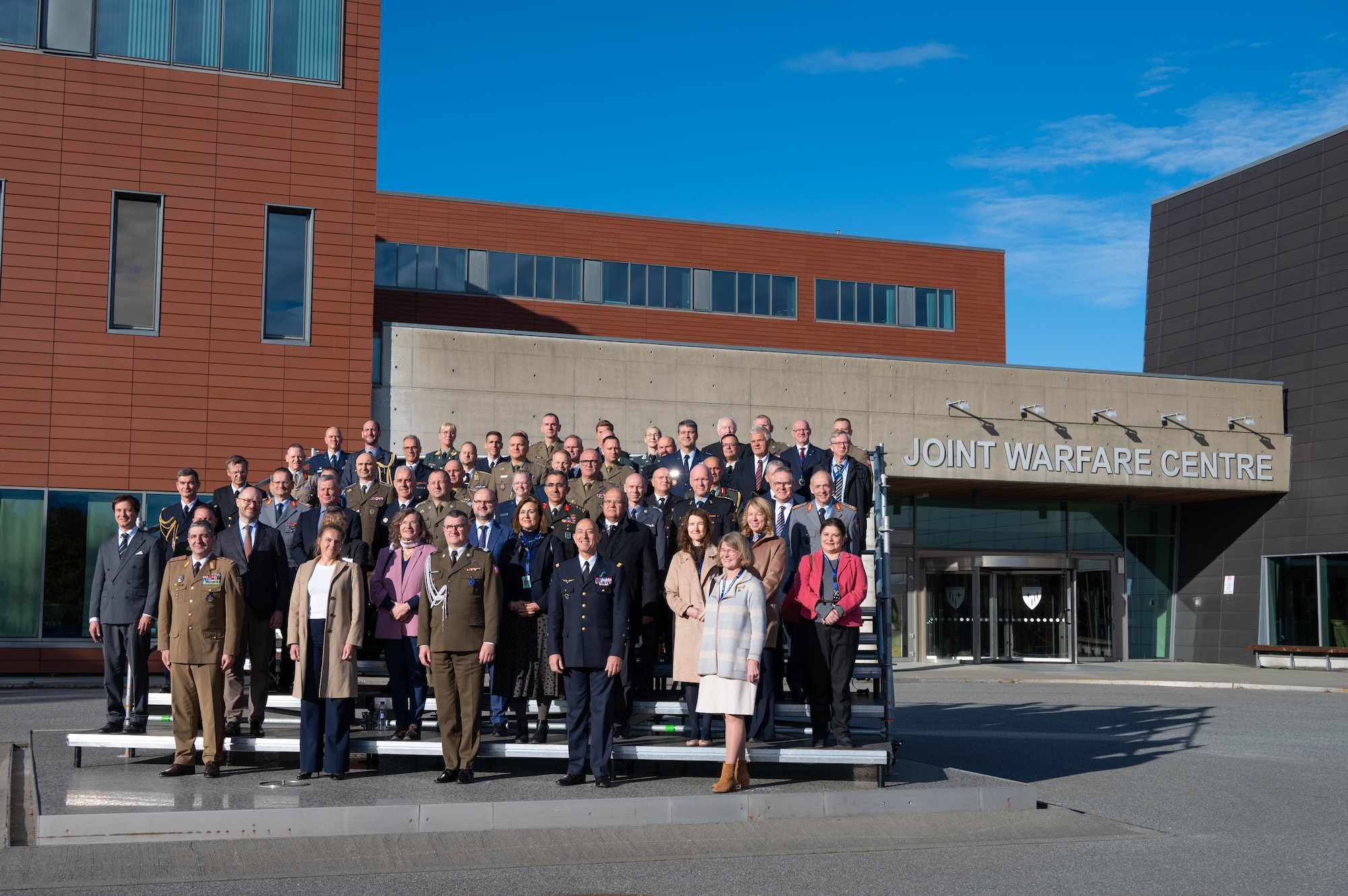 Military and civilian dignitaries pose for a group photo.