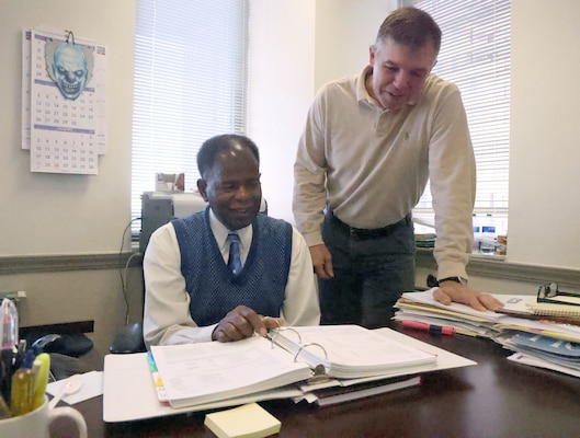 Willard Bush, U.S. Army Corps of Engineers, Mobile District accountant, and Brian Ivey, Chief of Resource Management, go over financial charts, Nov. 1, 2023, at the District headquarters in Mobile, Alabama. Ivey said Bush, who was his first supervisor, shared his vast knowledge of accounting with him and helped him in his career. (U.S. Army photo by Chuck Walker)