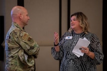 U.S. Air Force Chief Master Sgt. David Snarr, 628th Air Base Wing command chief, and Jamie McCarthy, Joint Base Charleston honorary commander, converse during an honorary commander induction ceremony on Joint Base Charleston, South Carolina, Nov. 2, 2023.